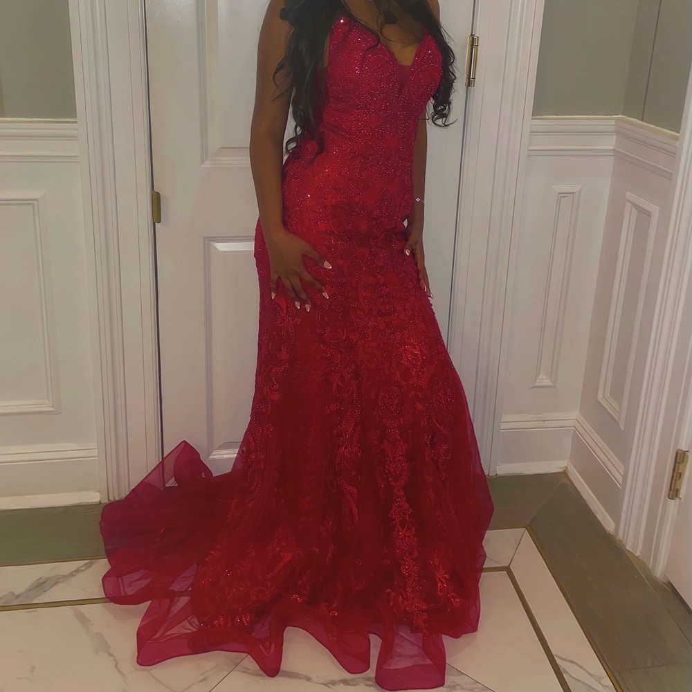 Red gown sleeveless sparkly sequence with gems, floor length flared end.